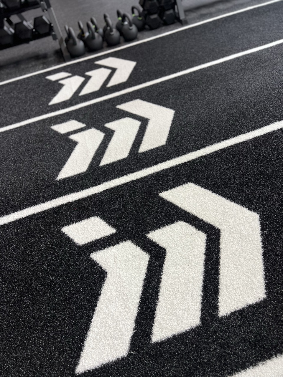 Identity branded turf with chevron arrows