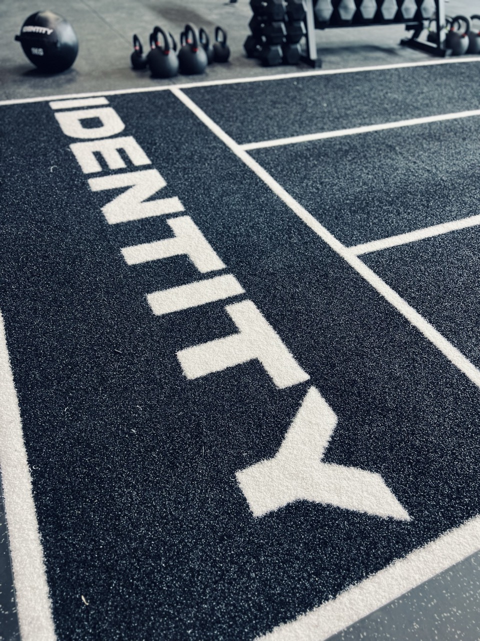 Identity training floor with kettlebells and dumbbells
