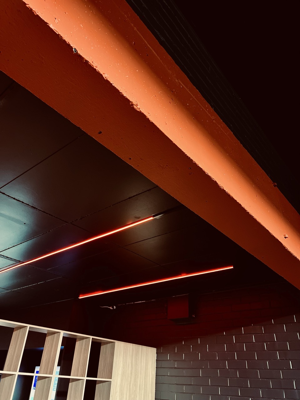Identity studio interior with signature orange beams