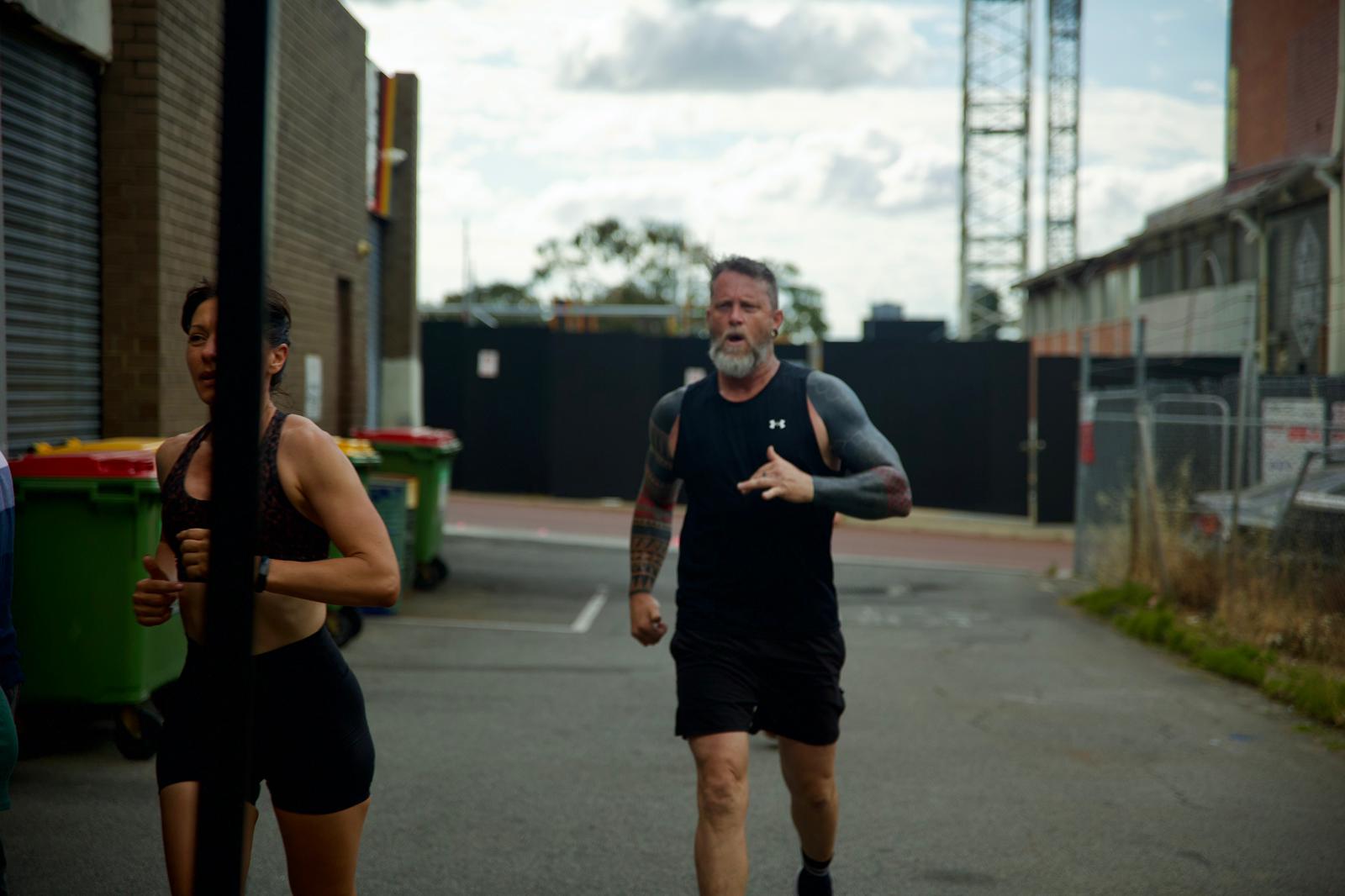 Members running together through West Perth